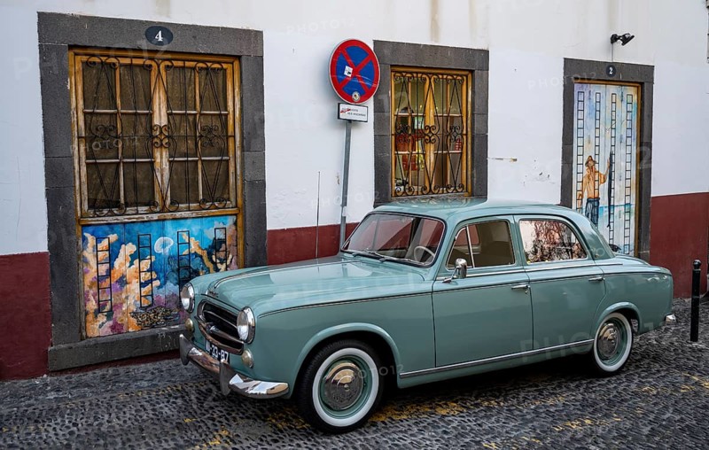 Vintage car in front of a house facade