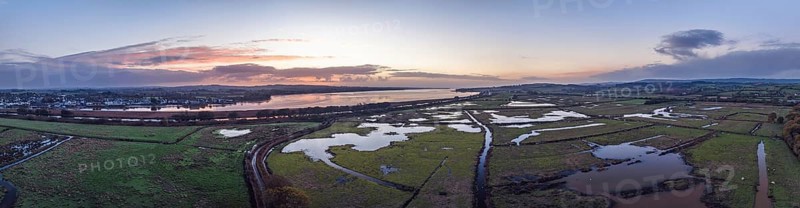 Sunrise over Wetlands and meadows in RSPB Exminster and Powderham Marshe from a drone