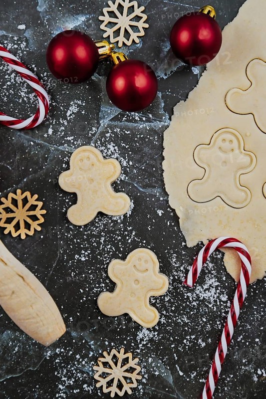 Overhead flat lay concept for baking Christmas cookies with rolled out cookie dough