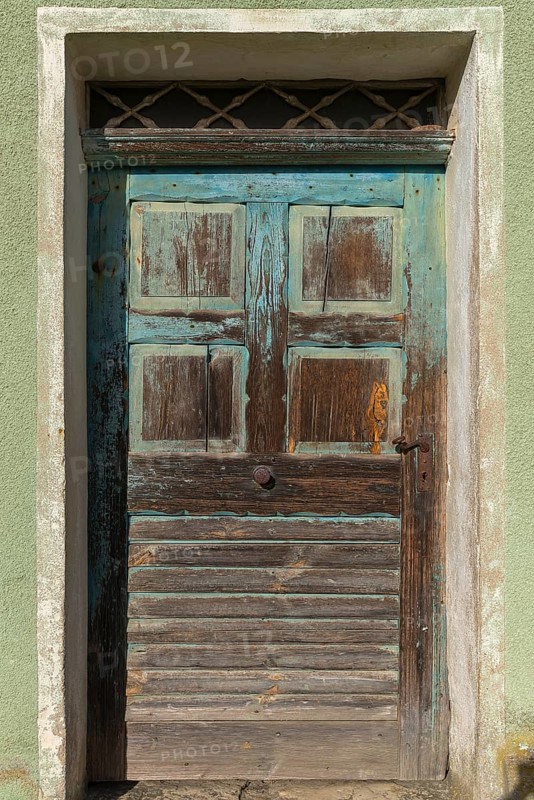 Old front door of a vacant farmhouse