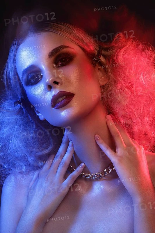 Portrait of a beautiful woman with bright evening makeup and colored filters. Beauty face