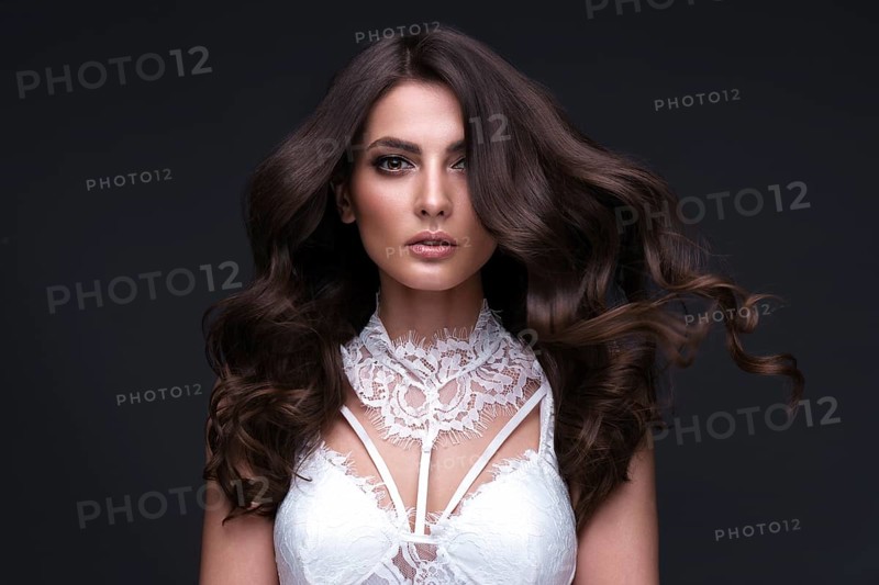 Beautiful brown-haired girl with a perfectly curls hair