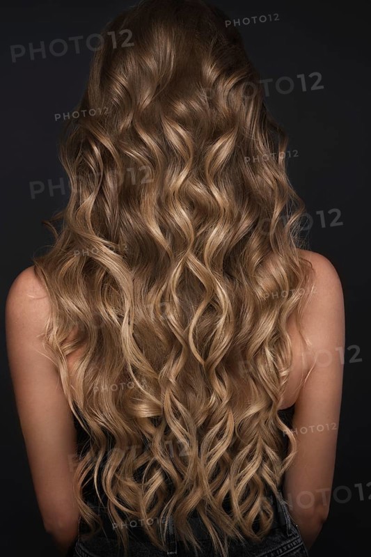 A closeup view of a bunch of shiny curls blond hair