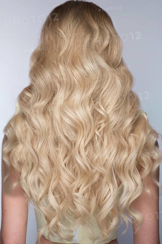 A closeup view of a bunch of shiny curls blond hair