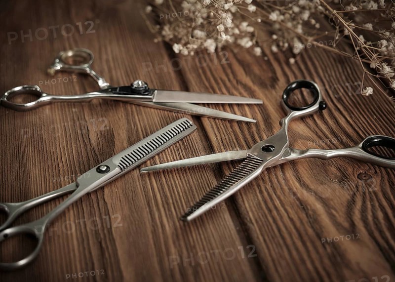 Hairdressing tools scissors closeup on wooden background. Close up