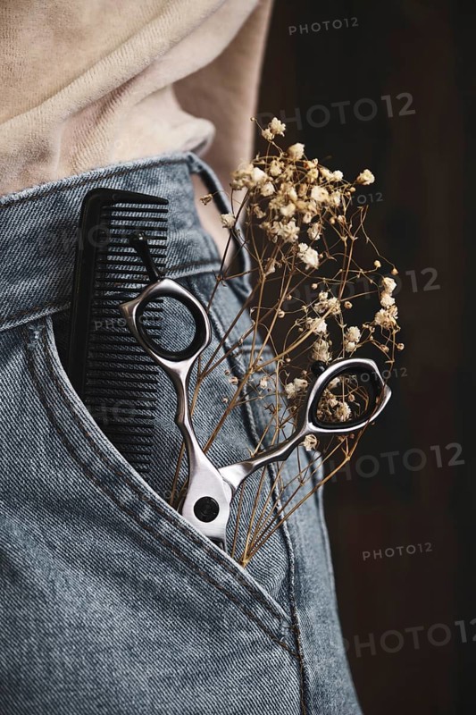 Hairdressing tools close-up in jeans with flowers