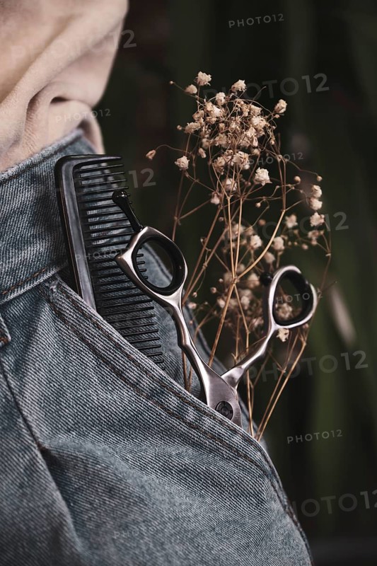 Hairdressing tools close-up in jeans with flowers