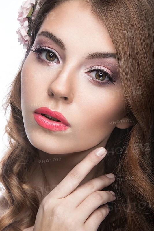 Portrait of a beautiful woman in the image of the bride with flowers in her hair. Picture taken in the studio on a black background
