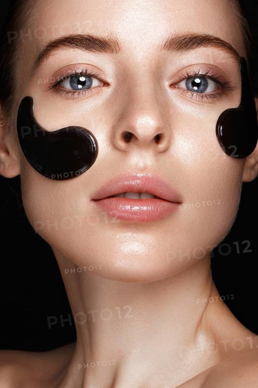 Beautiful fresh girl with cosmetic patches under the eyes
