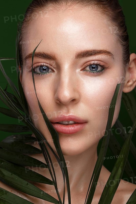 Beautiful fresh girl with cosmetic cream on the face