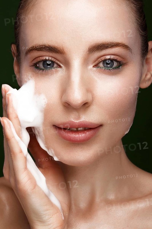 Beautiful young girl with facial wash on the skin. Beauty face. Picture taken in the studio