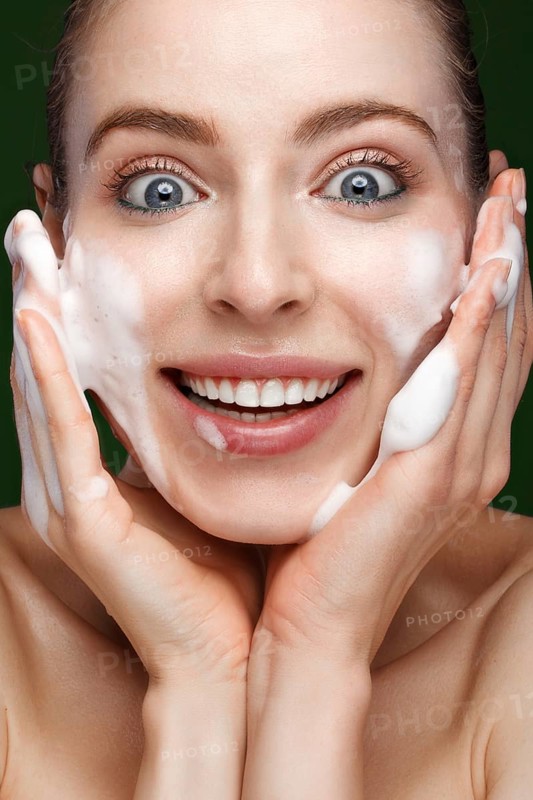 Beautiful young girl with cream on the skin. Beauty face. Picture taken in the studio