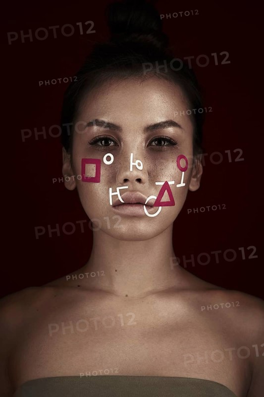 Portrait of a beautiful woman with an abstract pattern on her face. Creative makeup