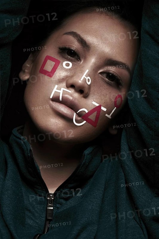 Portrait of a beautiful woman with an abstract pattern on her face. Creative makeup