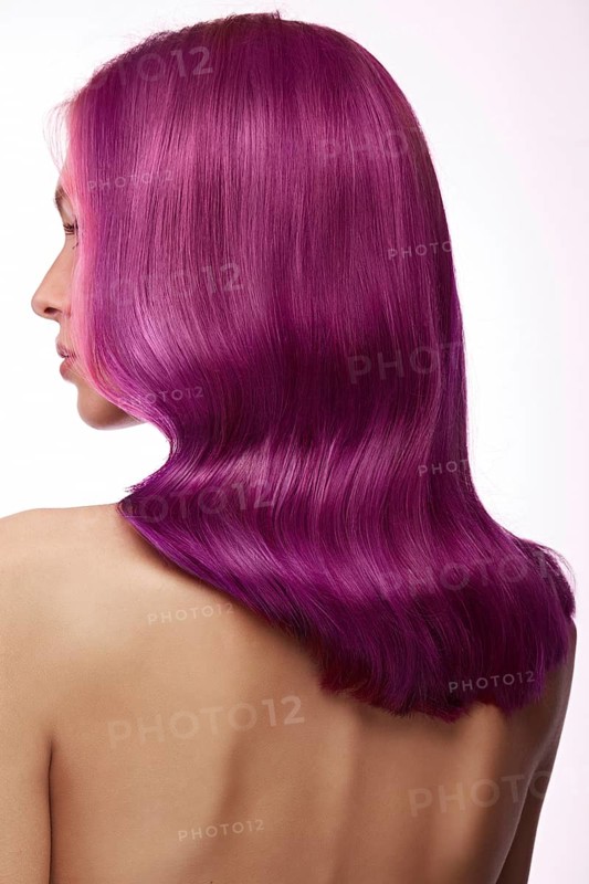 Beautiful girl with multi-colored hair and classic make-up and hairstyle. Beauty face. Photo taken in the studio