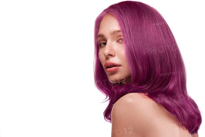 Beautiful girl with multi-colored hair and classic make-up and hairstyle. Beauty face. Photo taken in the studio