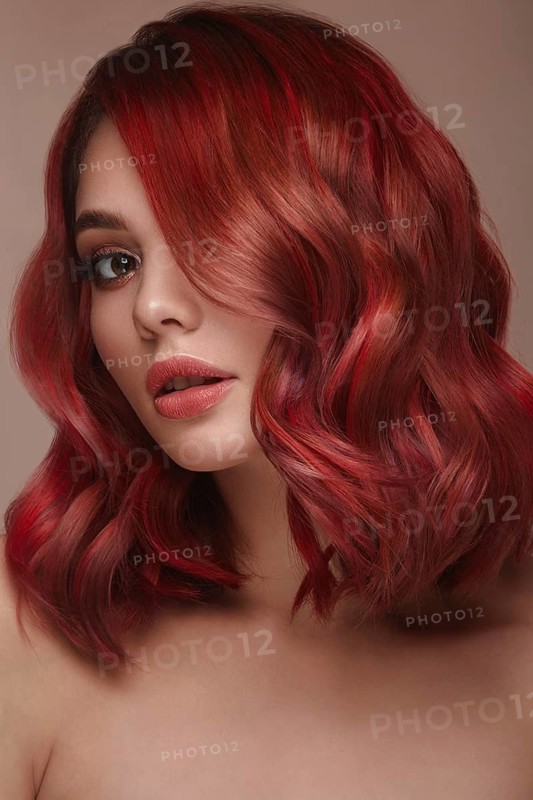 Beautiful girl with multi-colored hair and classic make-up and hairstyle. Beauty face. Photo taken in the studio