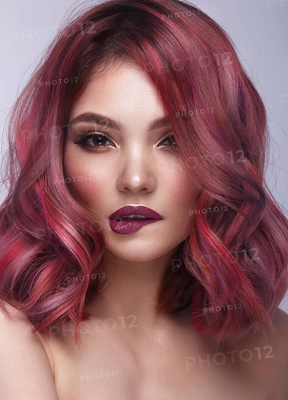 Beautiful girl with multi-colored hair and classic make-up and hairstyle. Beauty face. Photo taken in the studio