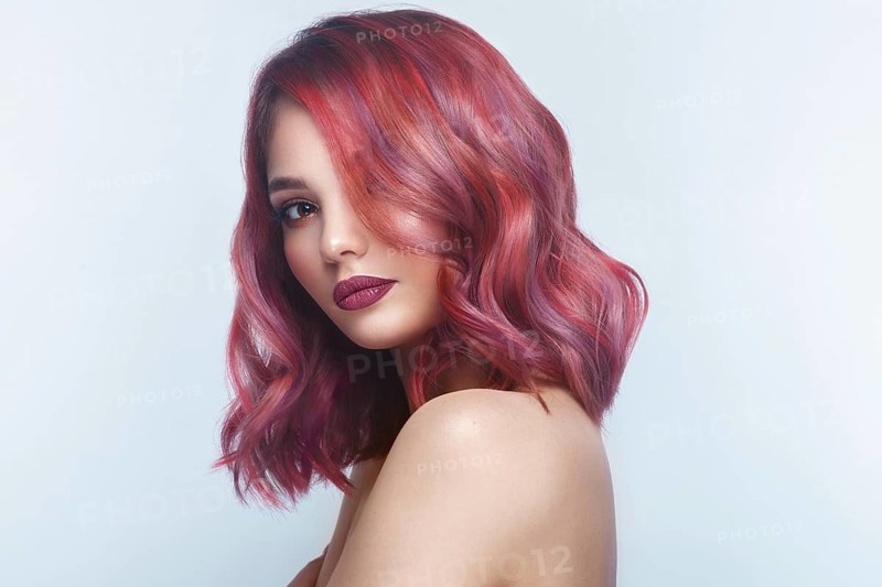 Beautiful girl with multi-colored hair and classic make-up and hairstyle. Beauty face. Photo taken in the studio