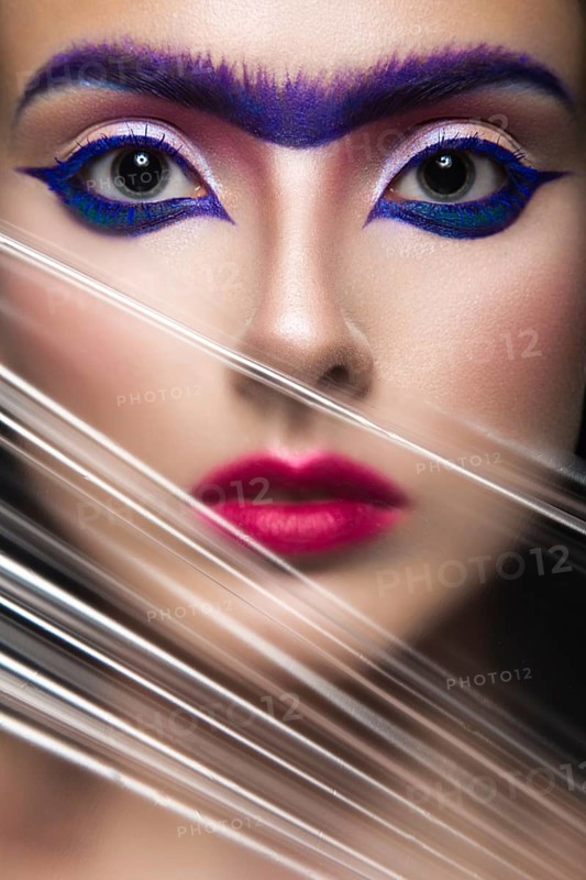 Fashion model with bright make-up art with a solid eyebrow. Creative image. Picture taken in the studio