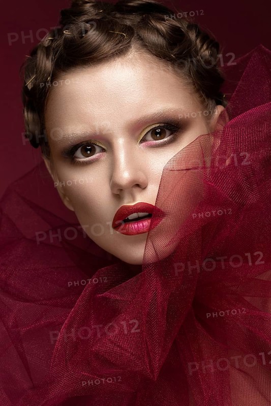 Beautiful girl with art creative make-up in the image of a red bride for Halloween. Beauty face. Photo taken in studio