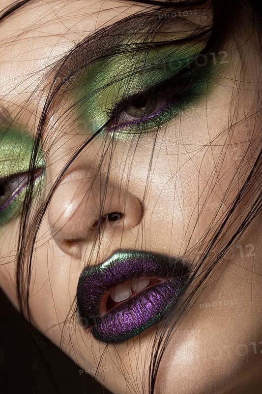Beautiful girl with spring green makeup and vampire lips. beauty face. Photos shot in studio