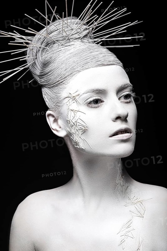 Art fashion girl with white skin and unusual hairstyle. Creative art beauty. Picture taken in the studio on a black background