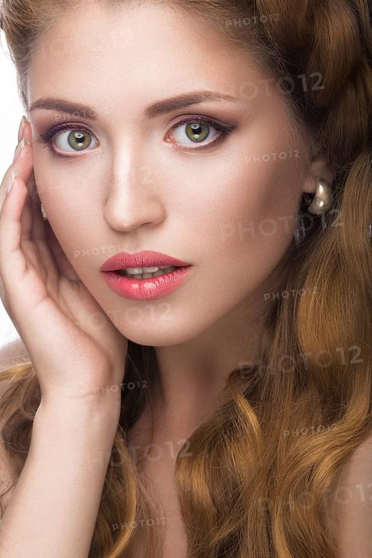 Fashion beautiful girl oriental type with delicate natural make-up and flowers. Beauty face. Picture taken in the studio on a white background