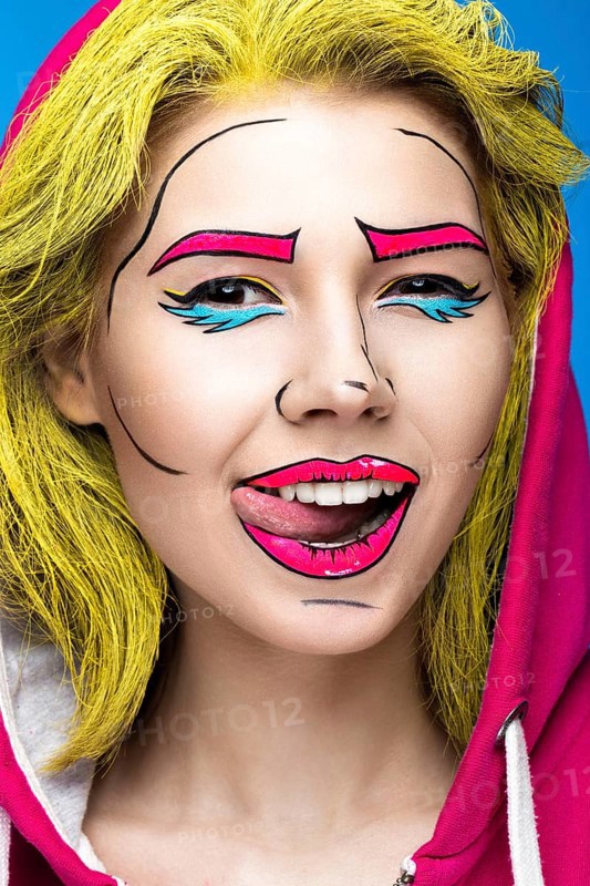 Photo of surprised young woman with professional comic pop art make-up. Creative beauty style. Photos shot in studio
