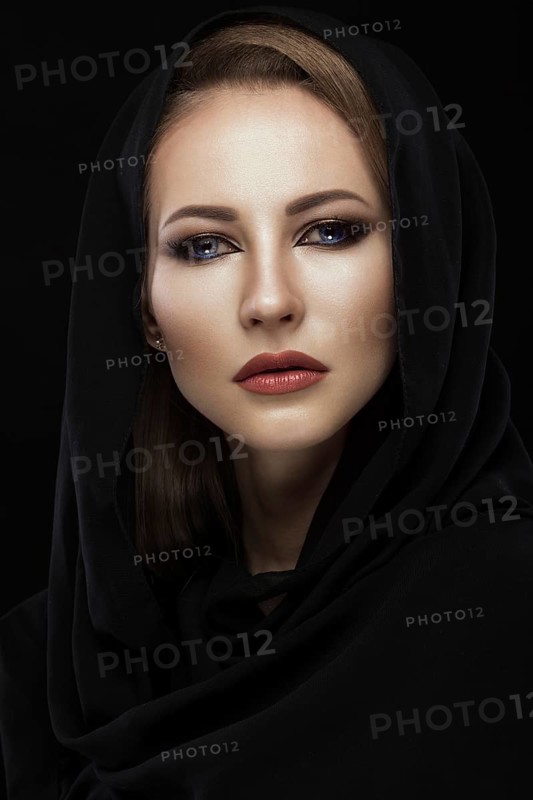 Beautiful girl in the Arab scarf with oriental make-up. Beauty face. Photos shot in the studio