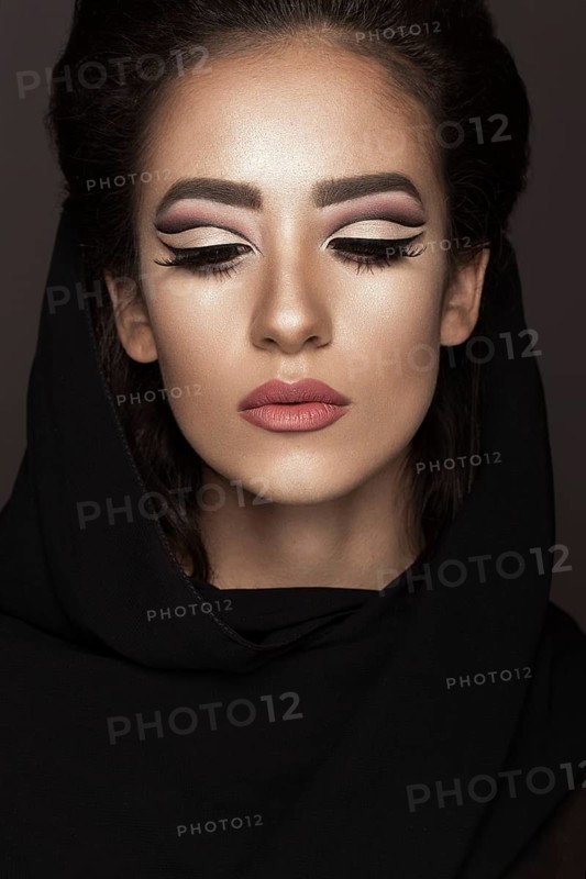 Beautiful girl in the Arab scarf with oriental make-up. Beauty face. Photos shot in the studio