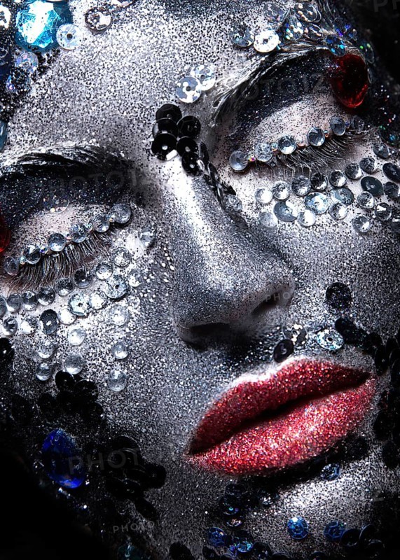 Girl with glitter and rhinestones on her face. Beauty close-up. Picture taken in the studio