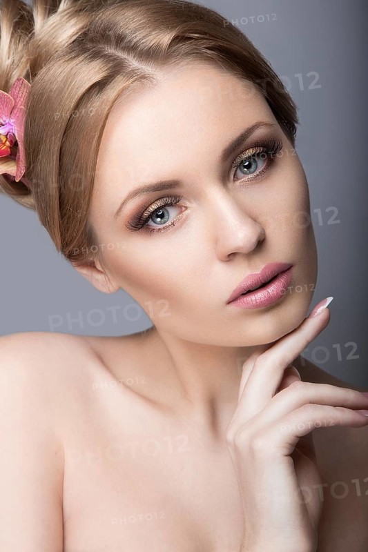 Portrait of a beautiful woman in the image of the bride with flowers in her hair. Picture taken in the studio on a black background