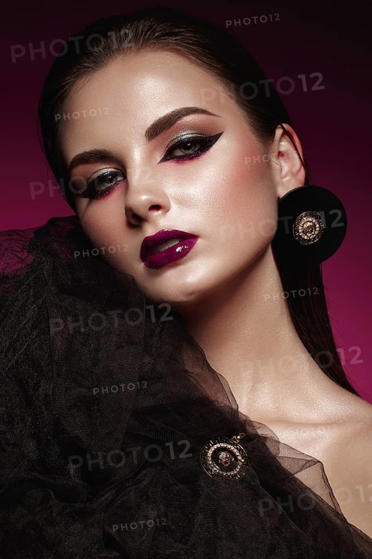Beautiful girl with bright creative make-up and graphic arrows. Beauty face. Photos shot in studio