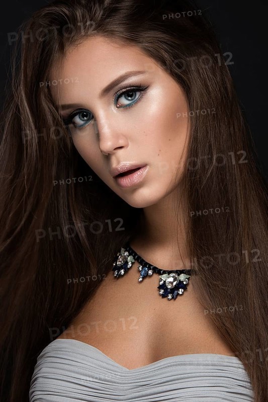 Beautiful woman with evening make-up and long straight hair