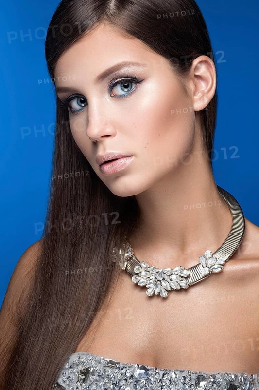 Beautiful woman with evening make-up and long straight hair