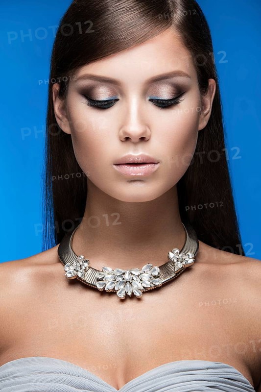 Beautiful woman with evening make-up and long straight hair