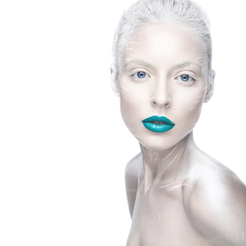 Beautiful girl in the image of albino with blue lips and white eyes. Art beauty face. Picture taken in the studio on a white background
