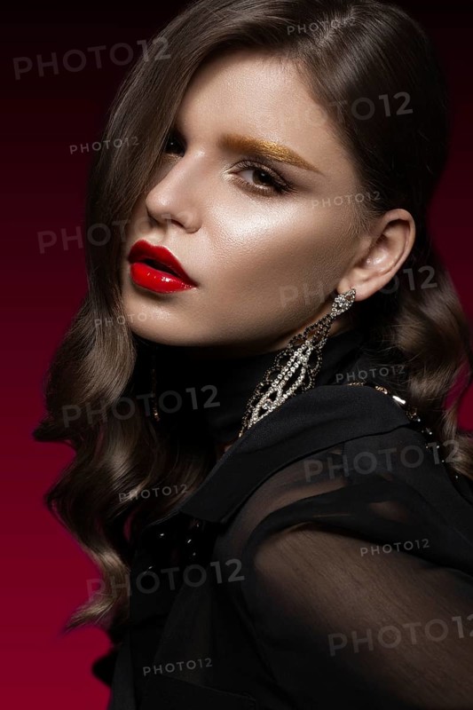 Beautiful girl with red lips and golden eyebrows