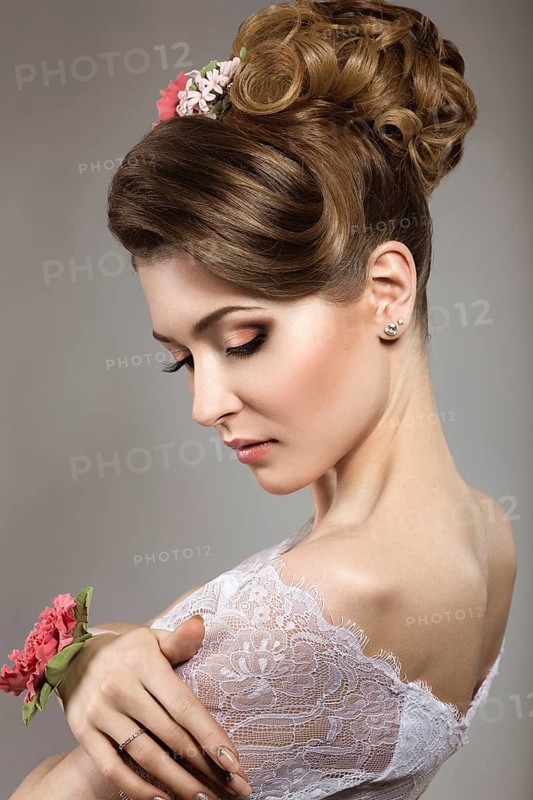 Portrait of a beautiful woman in the image of the bride with flowers in her hair. Picture taken in the studio on a black background