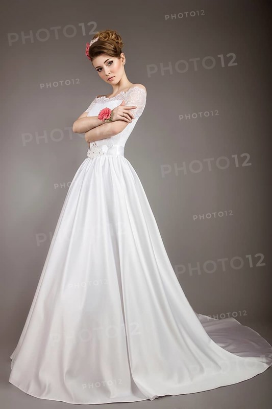 Portrait of a beautiful woman in the image of the bride with flowers in her hair. Picture taken in the studio on a black background
