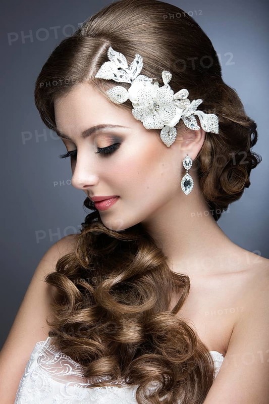 Portrait of a beautiful woman in the image of the bride accessory. Picture taken in the studio on a black background