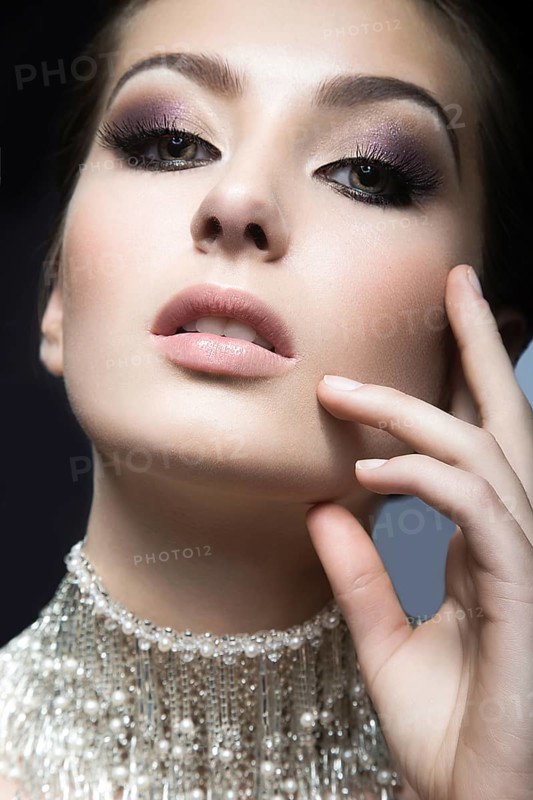 Portrait of a beautiful woman in the image of the bride accessory. Picture taken in the studio on a black background