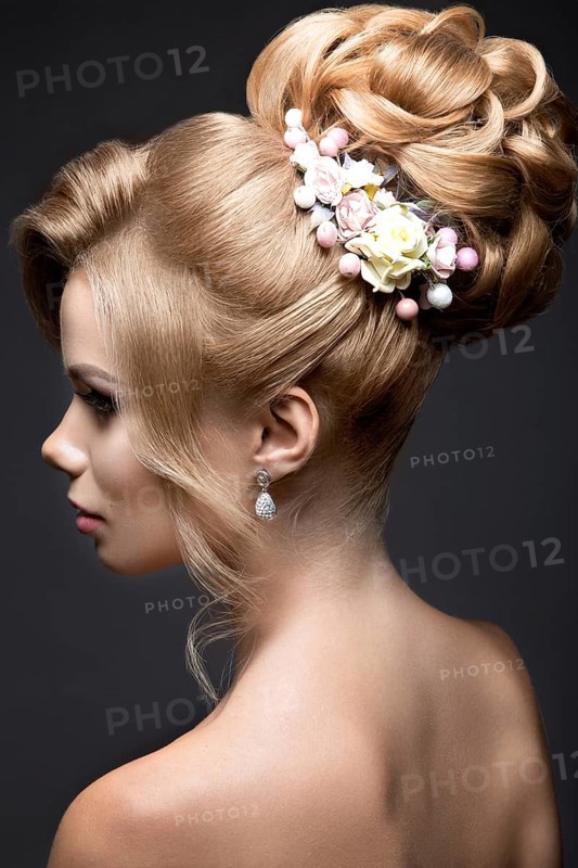 Portrait of a beautiful blond woman in the image of the bride. Picture taken in the studio on a black background. Beauty face and Hairstyle