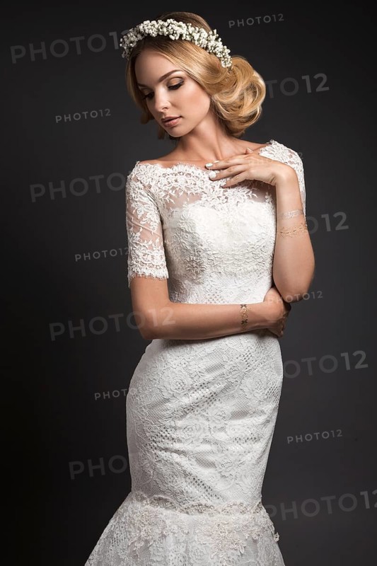 Portrait of a beautiful girl with flowers on her hair. Beauty face. Photo shot in the Studio on a black background. Wedding image in the style boho