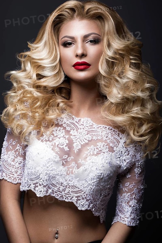 Beautiful blonde bride in wedding image with curls