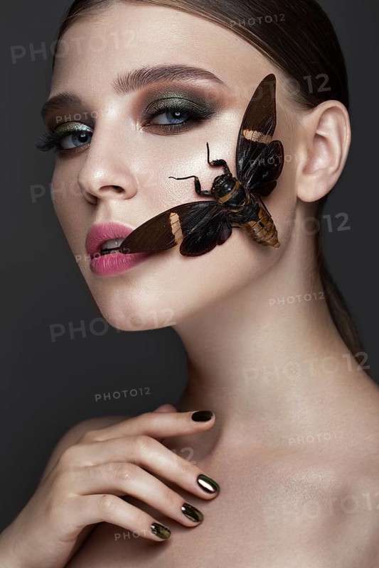 Portrait of beautiful girl with colorful make-up and cicada. Beauty face. Photo taken in the studio