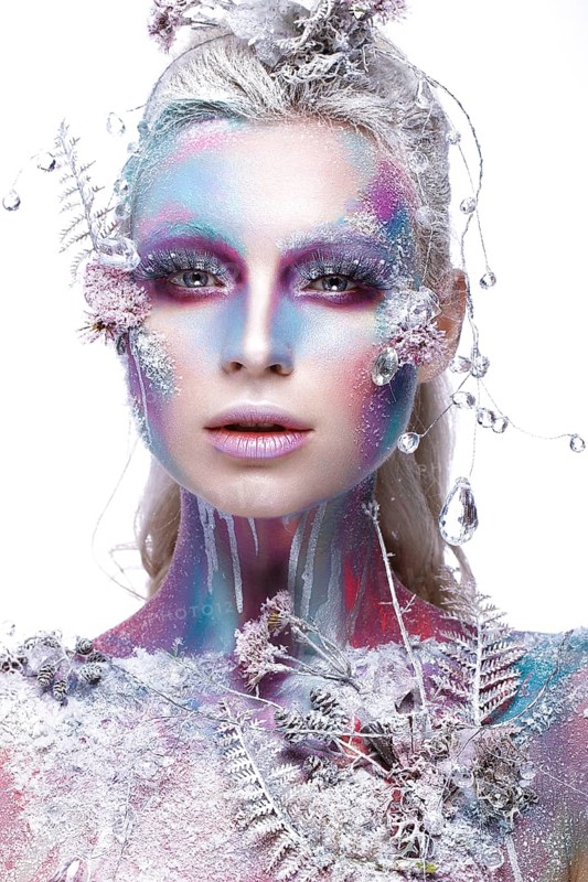 Beautiful girl in the image of a snowy unicorn creature. Creative make up. Art looks. Photo taken in the studio