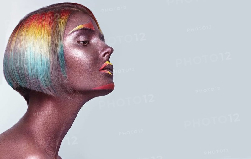 Beautiful girl with multi-colored hair and creative make up and hairstyle. Beauty face. Photo taken in the studio