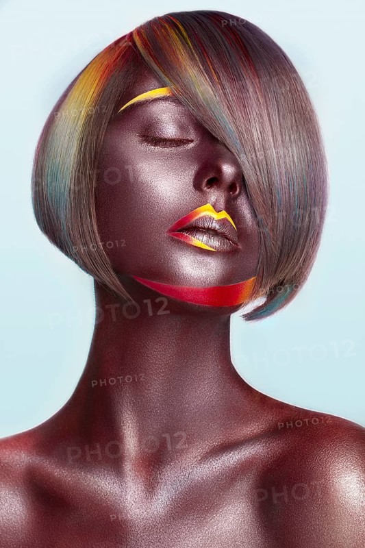 Beautiful girl with multi-colored hair and creative make up and hairstyle. Beauty face. Photo taken in the studio